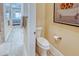Bright bathroom with a view of the bedroom and with modern fixtures, neutral tones, and tiled floors at 6104 Talon Preserve Dr, Nokomis, FL 34275