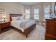 Comfortable bedroom featuring natural light from shuttered windows, complemented by classic wooden furniture and decor at 6104 Talon Preserve Dr, Nokomis, FL 34275