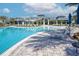 Resort-style community pool surrounded by palm trees and lounge chairs near the clubhouse at 6104 Talon Preserve Dr, Nokomis, FL 34275