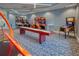 Community game room featuring arcade games, shuffleboard, and carpeted flooring at 6104 Talon Preserve Dr, Nokomis, FL 34275