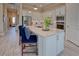 Bright kitchen featuring an island, breakfast bar, modern appliances, and ample counter space at 6104 Talon Preserve Dr, Nokomis, FL 34275