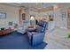 Inviting living room showcasing stylish seating and decor, leading to a modern kitchen with stainless steel appliances at 6104 Talon Preserve Dr, Nokomis, FL 34275
