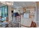 Open-concept living space with dining area and kitchen featuring a large island, seamlessly connecting to the living room at 6104 Talon Preserve Dr, Nokomis, FL 34275