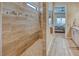 Stylish main bathroom with a tiled walk-in shower, modern fixtures, and seamless access to the main bedroom at 6104 Talon Preserve Dr, Nokomis, FL 34275