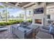Inviting outdoor lounge area with a cozy fireplace, comfortable seating, and a view of the pool at 6104 Talon Preserve Dr, Nokomis, FL 34275