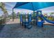 Community playground featuring shaded play structures and wood chip ground covering at 6104 Talon Preserve Dr, Nokomis, FL 34275