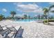 Relaxing pool area featuring a large pool, sun loungers, and lush tropical landscaping at 6104 Talon Preserve Dr, Nokomis, FL 34275