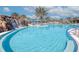 Beautiful pool with a waterfall feature and palm trees, perfect for relaxation and recreation at 6104 Talon Preserve Dr, Nokomis, FL 34275