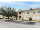 Inviting multi-Gathering home features a beige stucco exterior, dormer windows and well-maintained landscaping at 6434 Cypressdale Dr # 102, Riverview, FL 33578