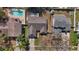 Overhead view of a landscaped home with a driveway and attached two-car garage in a residential neighborhood at 6908 Shady Pl, Tampa, FL 33634