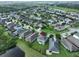 High-angle view of the property situated amongst community, waterways, and green landscape at 7010 Old Benton Dr, Apollo Beach, FL 33572