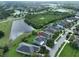 Aerial view of home showcasing its location near a pond and lush greenery at 7010 Old Benton Dr, Apollo Beach, FL 33572