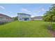 Expansive backyard featuring a well-manicured lawn, ideal for entertaining and recreation at 7010 Old Benton Dr, Apollo Beach, FL 33572