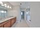 Bright bathroom with a double sink vanity, granite countertops, and a glass-enclosed shower at 7010 Old Benton Dr, Apollo Beach, FL 33572