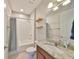 Cozy bathroom featuring modern fixtures, granite counters, and tiled floors at 7010 Old Benton Dr, Apollo Beach, FL 33572