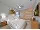Comfortable bedroom featuring light wood accents, simple decor, and a soothing color scheme at 7010 Old Benton Dr, Apollo Beach, FL 33572
