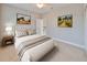 Cozy bedroom with neutral tones, a ceiling fan, and serene artwork enhancing the room's ambiance at 7010 Old Benton Dr, Apollo Beach, FL 33572