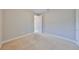 Neutral carpeted bedroom with ample light from the entryway, closet, and hall doors at 7010 Old Benton Dr, Apollo Beach, FL 33572