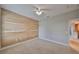 Well-lit bedroom with feature wall, carpet, and a view of the hallway through the open door at 7010 Old Benton Dr, Apollo Beach, FL 33572