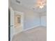 Well-lit bedroom with carpet, a ceiling fan, and a view of the hall through the open door at 7010 Old Benton Dr, Apollo Beach, FL 33572