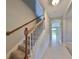 Hallway with staircase, carpeted steps and tiled floor leading to the upper floors at 7010 Old Benton Dr, Apollo Beach, FL 33572