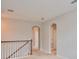 Second story carpeted hallway with stained banister leading to bedrooms at 7010 Old Benton Dr, Apollo Beach, FL 33572