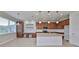Spacious kitchen with white subway tile backsplash, granite counters, desk and stainless steel appliances at 7010 Old Benton Dr, Apollo Beach, FL 33572