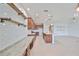 Modern kitchen featuring ample counter space, open shelving, and a sleek granite island at 7010 Old Benton Dr, Apollo Beach, FL 33572