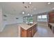 Modern kitchen island with granite countertops, stainless steel sink, and cabinetry at 7010 Old Benton Dr, Apollo Beach, FL 33572