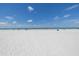 Panoramic beach view showing the shoreline with people enjoying the ocean under a clear, sunny sky at 704 180Th E Ave, Redington Shores, FL 33708