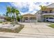 Charming single-story home with lush landscaping and a spacious driveway at 704 180Th E Ave, Redington Shores, FL 33708