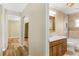Bathroom featuring wood-look flooring, wood vanity, mirror and bath/shower at 7281 61St N Ave, St Petersburg, FL 33709