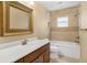 Bathroom featuring tile flooring, wood vanity, large framed mirror and tub at 7281 61St N Ave, St Petersburg, FL 33709