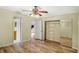 Bedroom features wood-look flooring, ceiling fan, and mirrored sliding closet doors at 7281 61St N Ave, St Petersburg, FL 33709