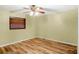 Bedroom with wood-look flooring, ceiling fan, blinds and natural light at 7281 61St N Ave, St Petersburg, FL 33709
