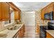 Traditional kitchen with wooden cabinets, stainless sink, and garden view at 7281 61St N Ave, St Petersburg, FL 33709