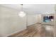 Spacious living room featuring hardwood floors and a decorative chandelier fixture at 7281 61St N Ave, St Petersburg, FL 33709