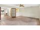Spacious living room features tile flooring, ceiling fan, neutral paint, and natural light at 7281 61St N Ave, St Petersburg, FL 33709