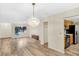Bright living space with hardwood floors, chandelier, closet, and views to kitchen at 7281 61St N Ave, St Petersburg, FL 33709