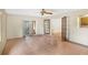 Open living room with tile floors, ceiling fan, and glass doors leading to a sunroom or patio at 7281 61St N Ave, St Petersburg, FL 33709