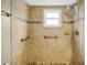Walk-in tile shower featuring a rainfall shower head, built-in niche, and safety bars at 7281 61St N Ave, St Petersburg, FL 33709