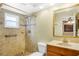 Updated tile shower with a built-in niche, a rainfall shower head and safety bars at 7281 61St N Ave, St Petersburg, FL 33709