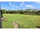 Lush backyard featuring a waterfront view with mature trees in a relaxing natural environment at 8010 Bally Money Rd, Tampa, FL 33610