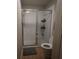 Bathroom features a glass shower and a toilet with tile floors at 8010 Bally Money Rd, Tampa, FL 33610