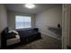 Bedroom with natural light from window and a bed with a dark comforter at 8010 Bally Money Rd, Tampa, FL 33610