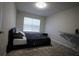 Cozy bedroom featuring neutral walls and carpet, complemented by natural light from a window at 8010 Bally Money Rd, Tampa, FL 33610
