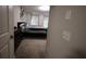 Carpeted bedroom with a glimpse of the bed, dresser, and two curtained windows at 8010 Bally Money Rd, Tampa, FL 33610