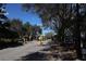 Gated community entrance with mature trees and clear signage for residents and visitors at 8010 Bally Money Rd, Tampa, FL 33610