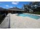 Community pool with a spacious deck, pool house, and lounge chairs for relaxation on a sunny day at 8010 Bally Money Rd, Tampa, FL 33610