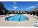 A community pool with lane markers with lounge chairs and a pool house offering a recreational outdoor space at 8010 Bally Money Rd, Tampa, FL 33610